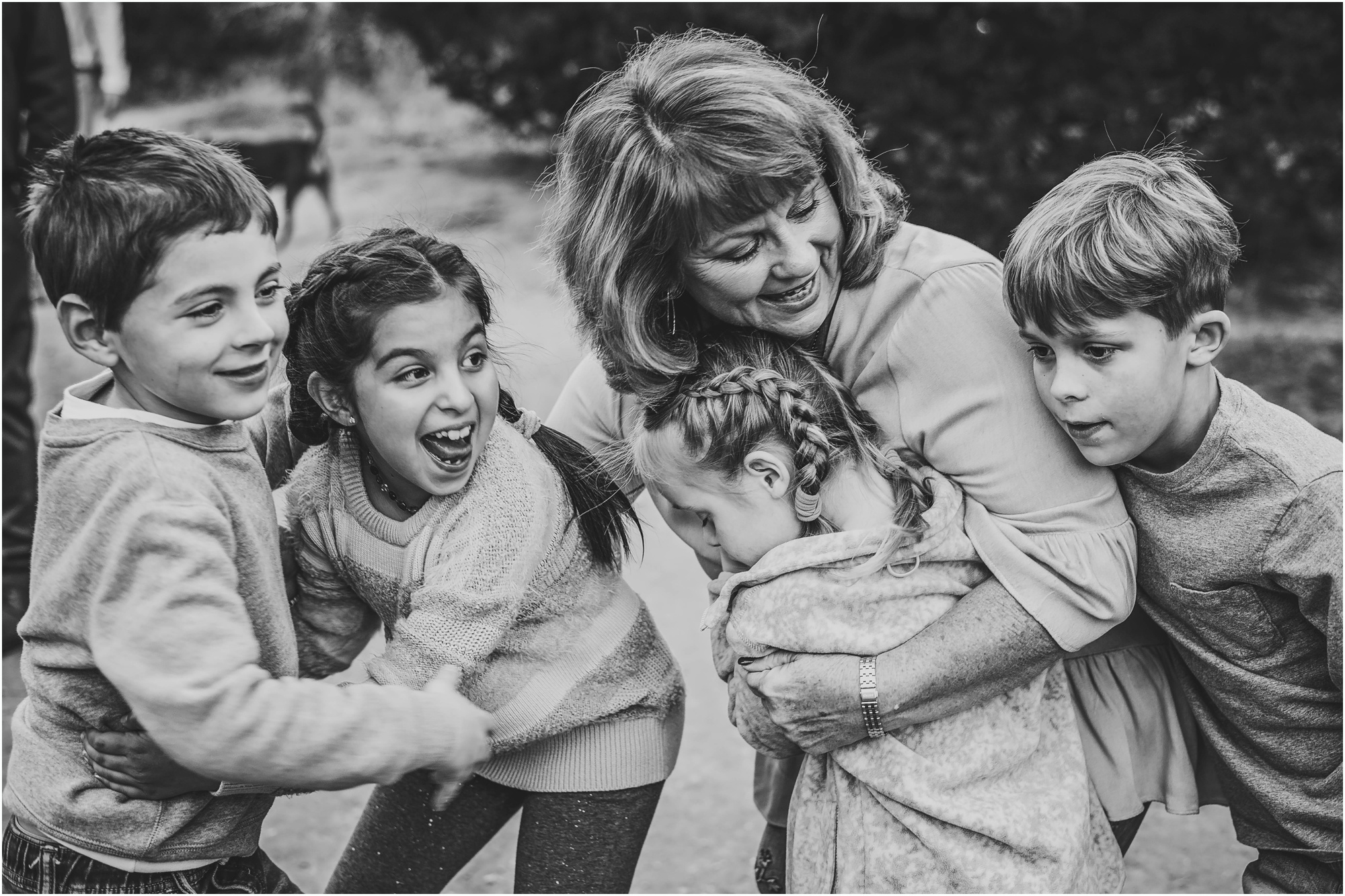 Grandmother with grandkids laughing at Walnut Creek Park Austin Texas Family Photographer