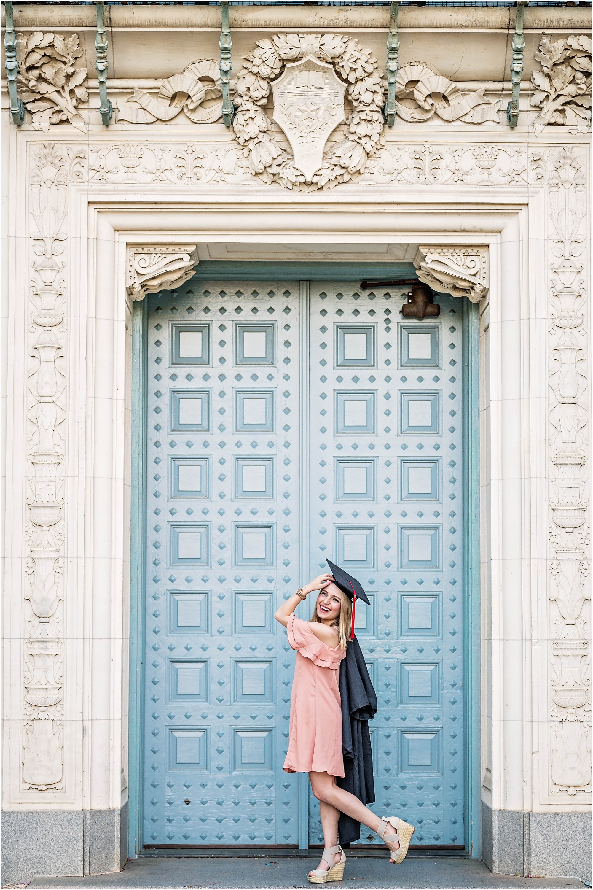 Girl in Pink Dress outside of Blue Door Graduation Photoshoot in Austin Texas by Natural Light Photographer University of Texas