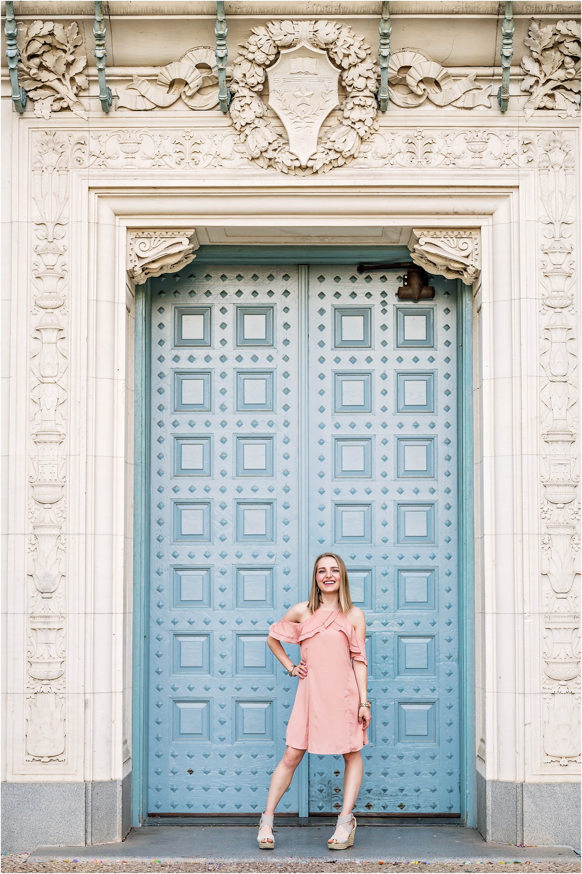 Girl in Pink Dress outside of Blue Door Graduation Photoshoot in Austin Texas by Natural Light Photographer University of Texas