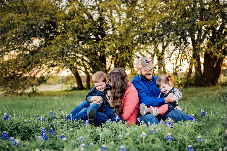 Family Giggling Together in Texas Bluebonnets Round Rock Texas Photographer