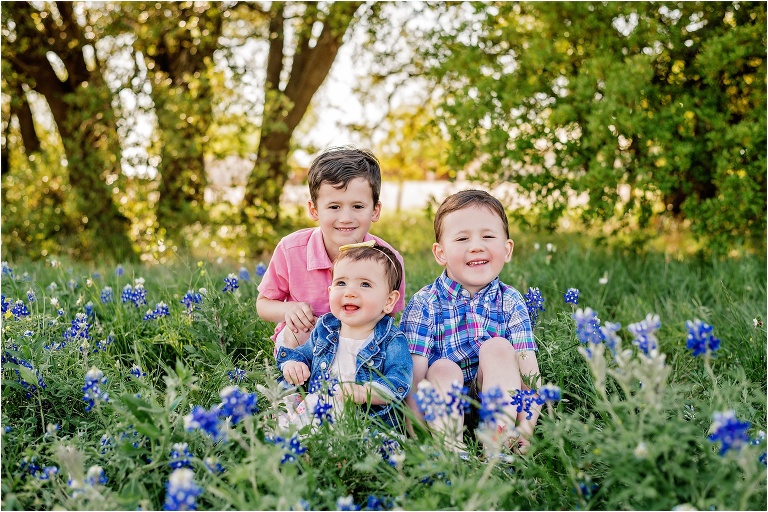 Sibling Children together in Bluebonnet Field in Round Rock Texas by Austin Texas Natural Light Child Photographer
