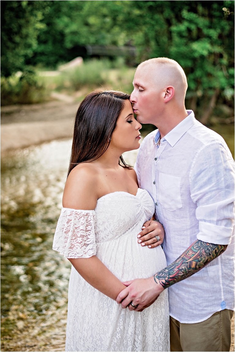 Maternity Photoshoot in Cedar Park Texas in white lace maxi dress kissing