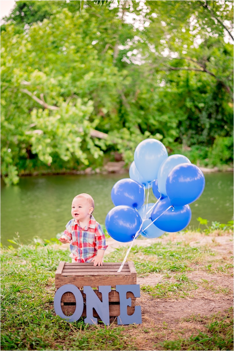 Little Boy Turns One with Blue Balloons at Round Rock Natural Light Photoshoot by Child Photographer