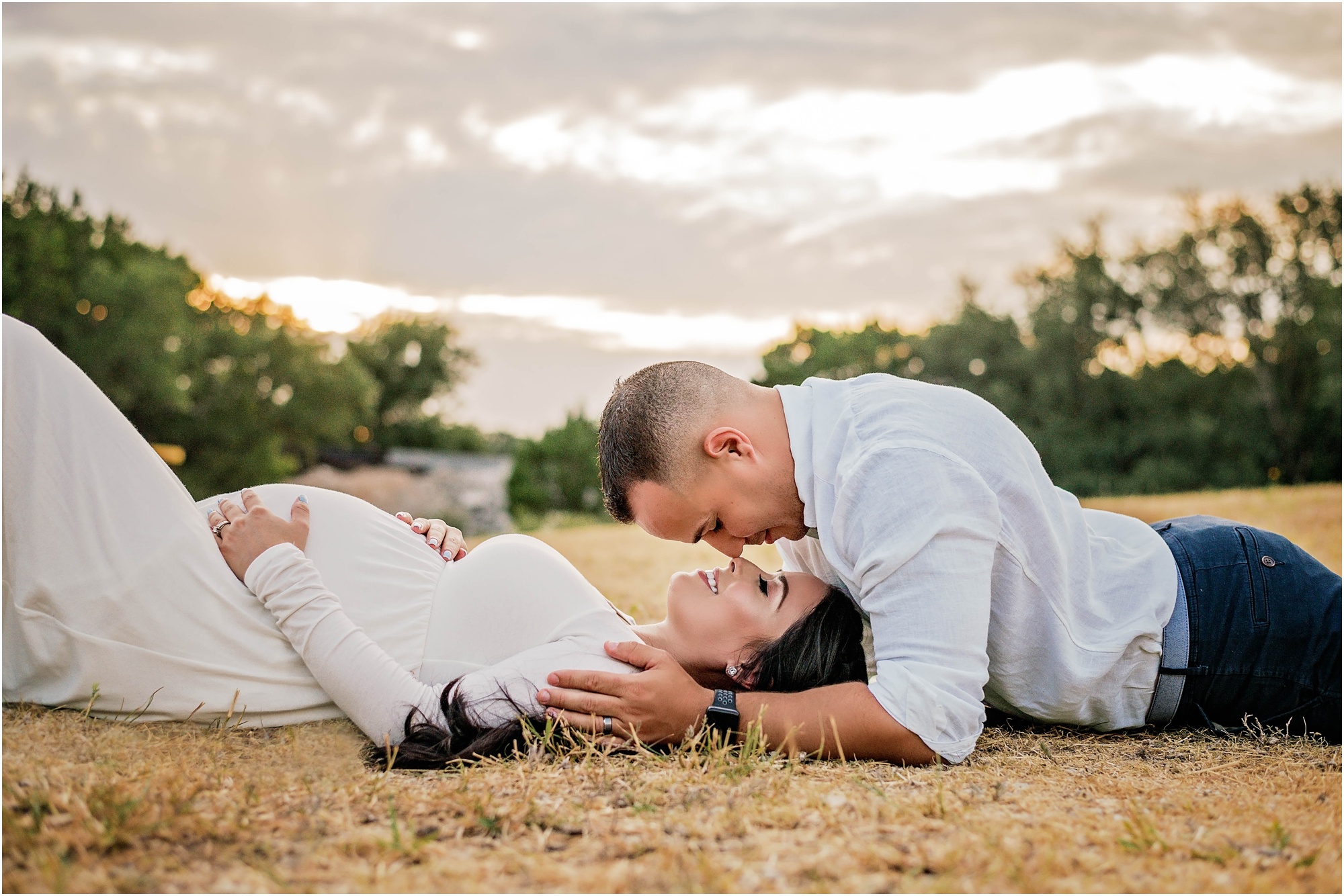 Couple in field during maternity photoshoot in Cedar Park Texas by natural light family photographer
