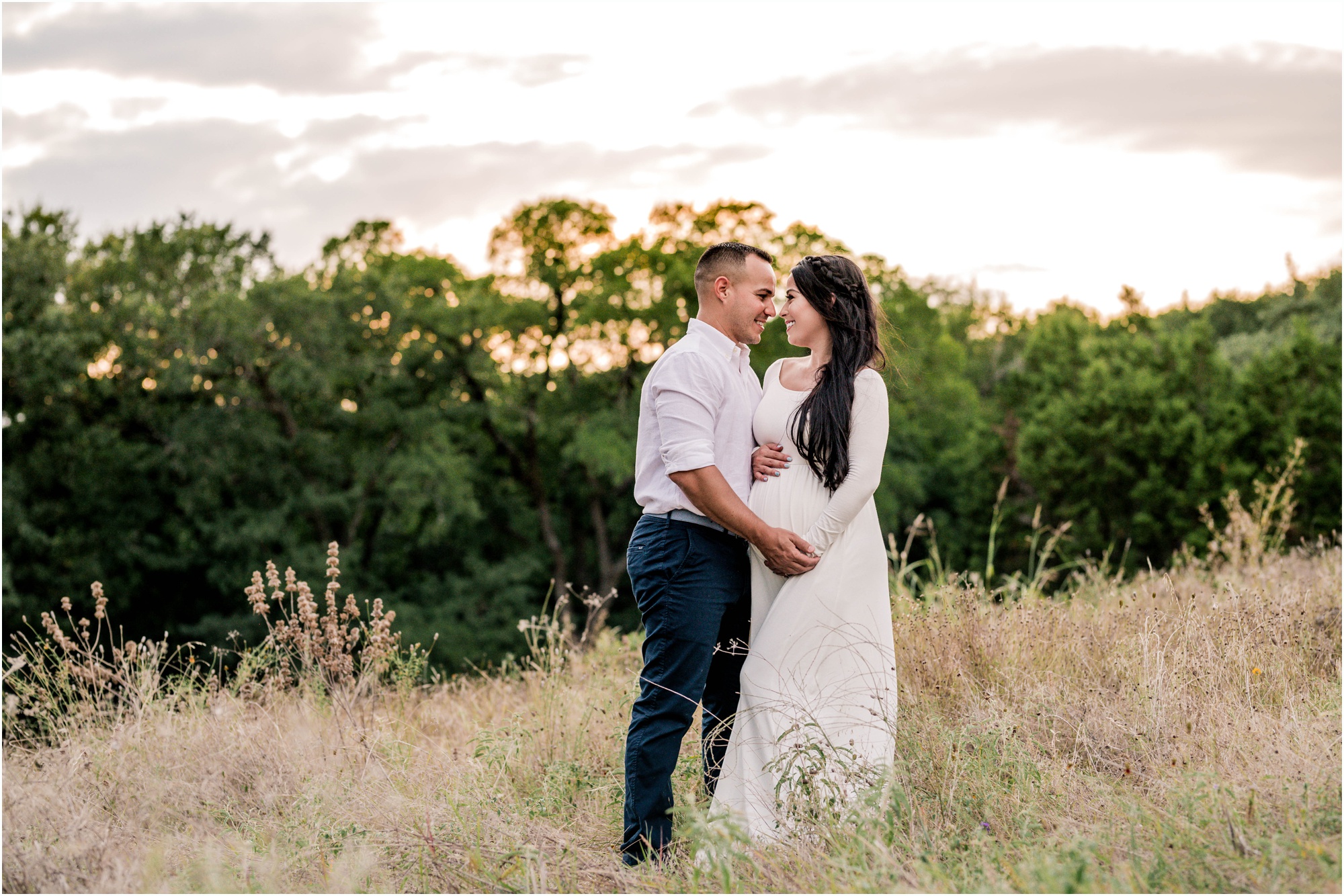 Couple in field during maternity photoshoot in Cedar Park Texas by natural light family photographer