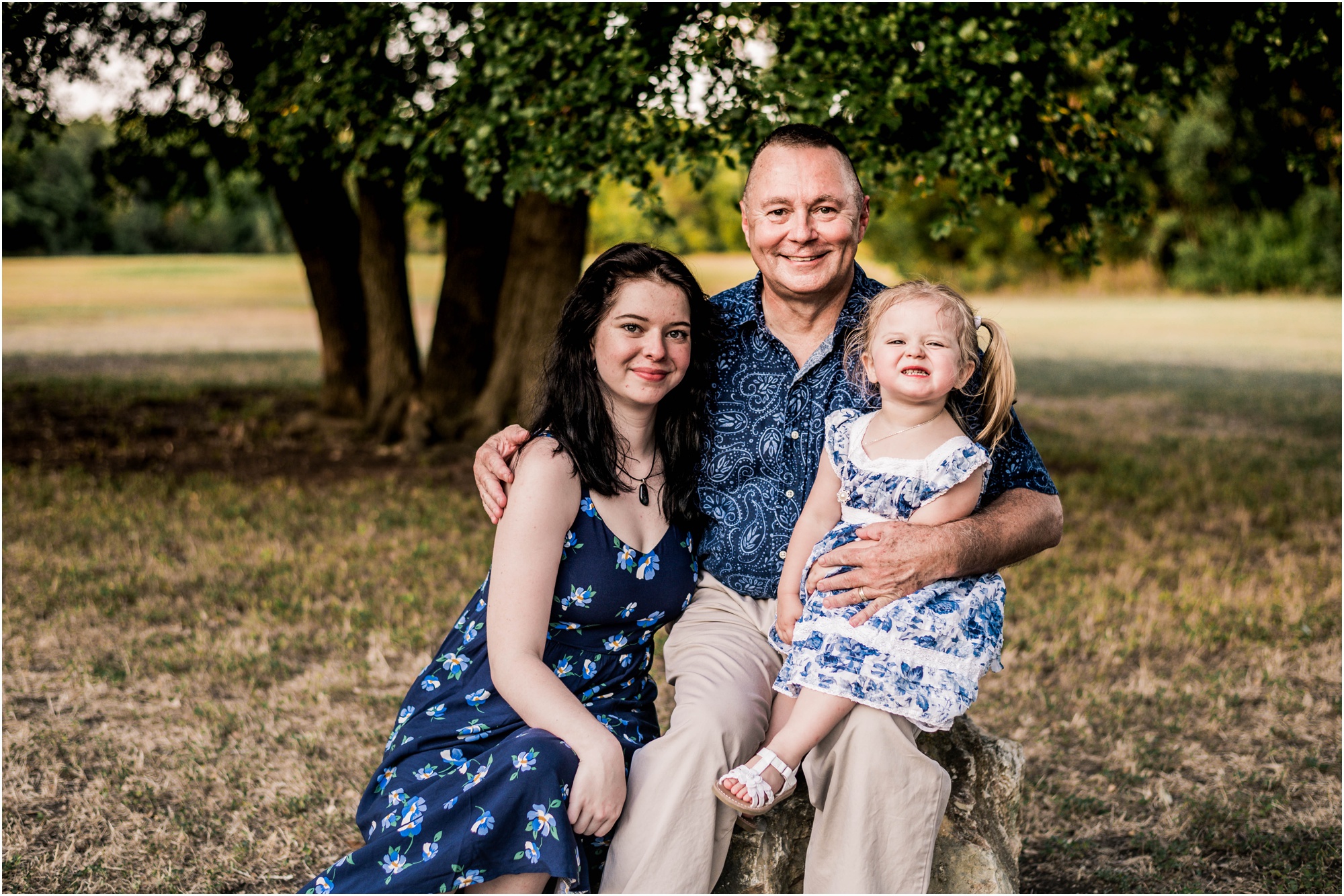 Grandfather and granddaughters in Austin Texas park by Natural Light photographer