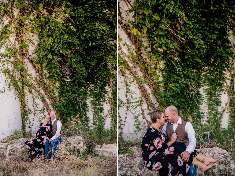 Couple in Georgetown Texas during natural light portrait photoshoot in front of vine wall