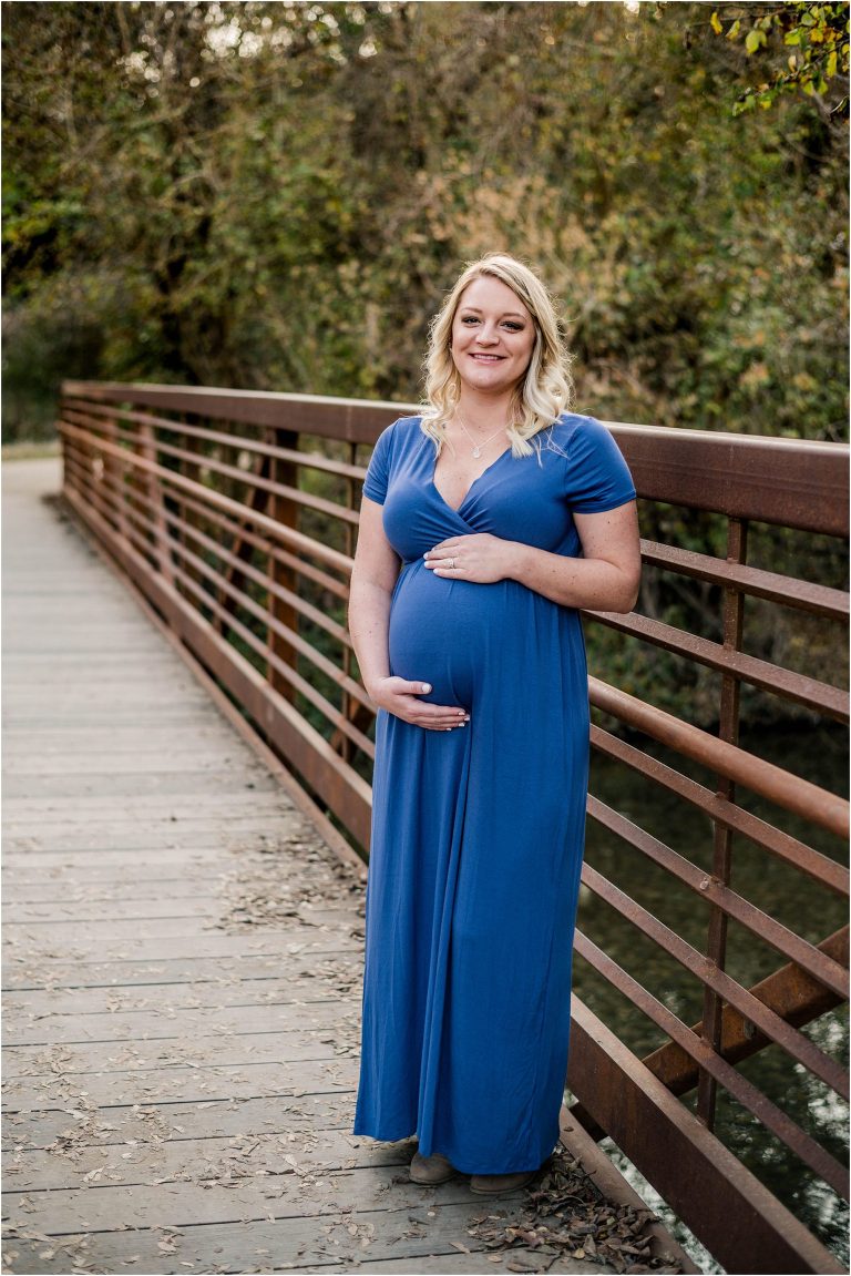 Beautiful expecting mother on bridge in Cedar Park Texas during maternity photoshoot with natural light milestone photographer