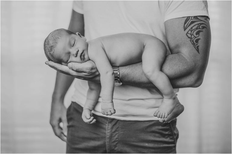 indoor newborn photoshoot with baby boy on father's arm austin texas baby photographer