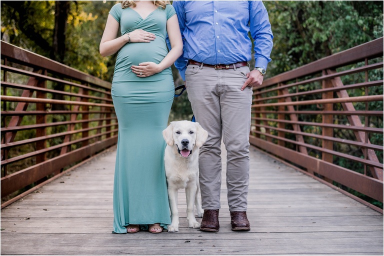 couple on bridge during maternity photoshoot with golden retriever puppy cedar park texas photographer