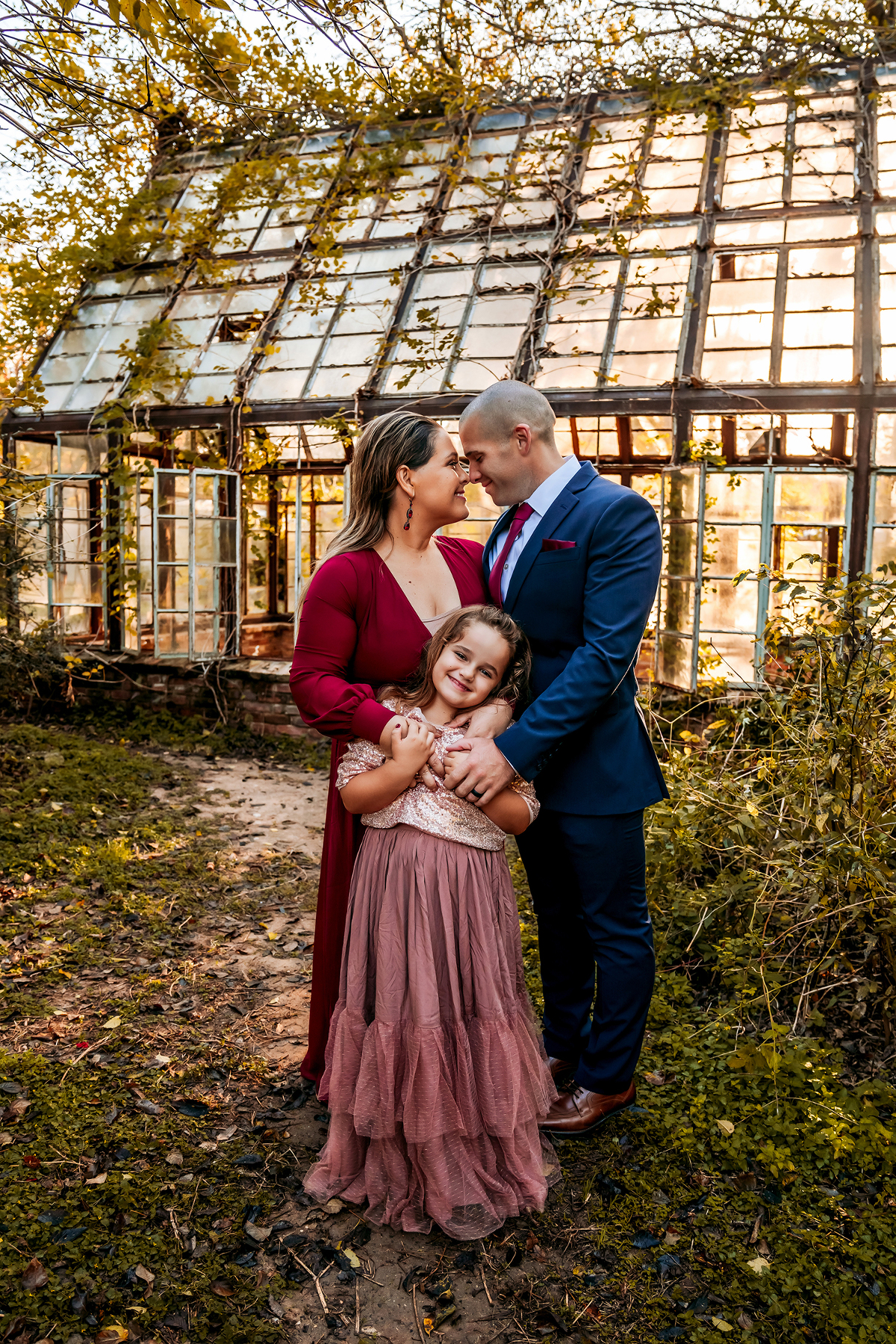 Family in front of greenhouse in Austin Texas by natural light portrait photographer